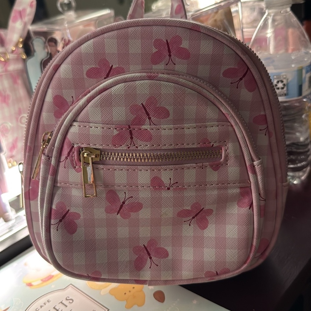 Pink butterfly bag that comes with straps that are adjustable turn to a backpack